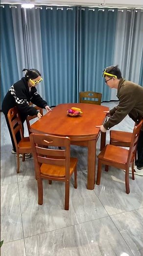 This is a modern wooden round dining table and chair set
