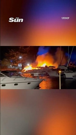 Shocking moment huge fire and ‘multiple explosions’ erupt at popular marina before two boats sink