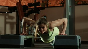 Strong woman doing push-ups in the gym - Free Stock Video