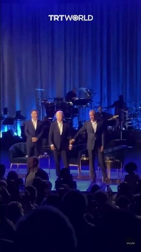 Obama takes Biden’s arm and leads him off stage