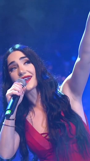 Female Performer Dazzles in Stunning Red Dress