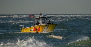It was very rough on Sunday morning at Moriches Inlet. Things happen fast and a boat with three guys aboard capsized just outside the inlet. Luckily Sea Tow was already there and plucked them out. Here is what I was able to capture. | Great South Bay Images/Mike Busch