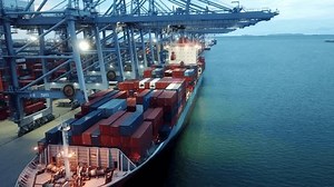 Container ship unloading in deep sea port, Global business logistic import export freight shipping transportation oversea worldwide by container ship open sea, Container vessel loading cargo freight.