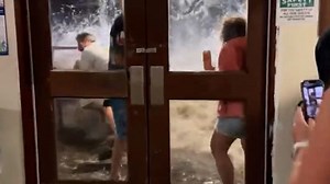 Video captures moment huge wave crashes into US military building