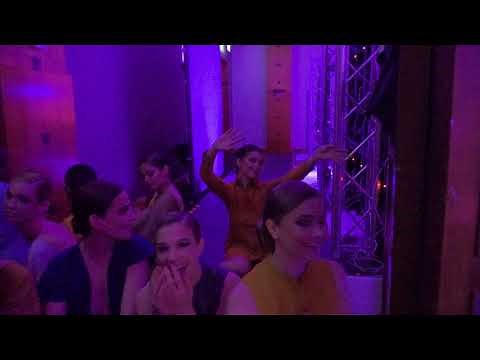 Models dancing in backstage during a fashion show
