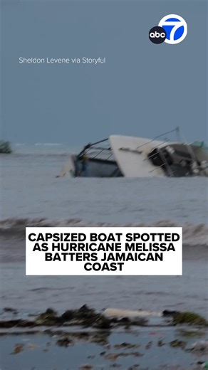 Footage shows a capsized boat near Old Harbour Bay, Jamaica, on Sunday, October 26, as powerful swells built ahead of Hurricane Jamaica. Footage recorded by Sheldon Levene shows the partially submerged boat floating near the shore. The National Hurricane Center said in an advisory on Monday that Category 5 Melissa was packing maximum sustained winds of 165 mph and was expected to bring “catastrophic and life-threatening” winds, flooding, and storm surge to Jamaica late Monday and early Tuesday. 