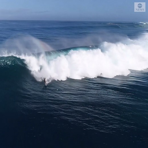 Stunning drone footage saw surfers in Hawaii catching the biggest swells of the season with surf reaching 50 feet on Saturday. https://abcn.ws/3bMNxMB | ABC News
