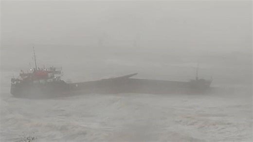 Aerial shots show a cargo ship broken in half after crashing into coastline in Turkey