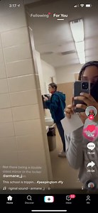 A one way mirror is in the girls locker room in a school