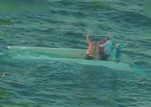Footage captures boaters in capsized boat waving for help before rescue