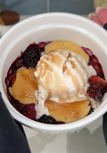 had to try the viral mini sugar cookie berry cobbler recipe 🍓🫐🍪 Ingredients: frozen mixed berries 3 pieces @Pillsbury sugar cookie dough vanilla ice cream mixed berry syrup (optional) Instructions: Add frozen berries to a ramekin filling it about halfway, then place 3 pieces of sugar cookie dough directly on top and slightly flatten to cover the berries. Air fry at 325 for 12-15 minutes or until the cookie dough is puffed and golden brown and the berries are bubbling around the edges. let coo