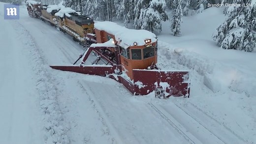 Train plow through snow at Donner Pass in the Sierra Nevada
